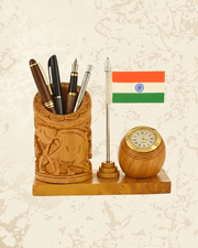 Handcrafted wooden pen stand with Indian flag design, analog clock, and elephant carving for desks.