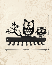 Decorative metal owl family key holder for wall mounting, combining home decor and everyday key storage.